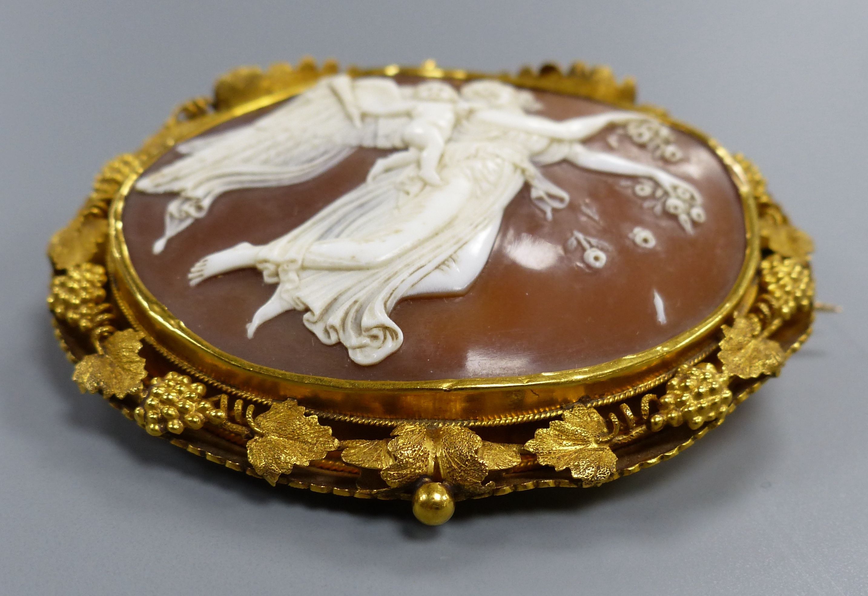 A Victorian pinchbeck and cameo shell brooch.